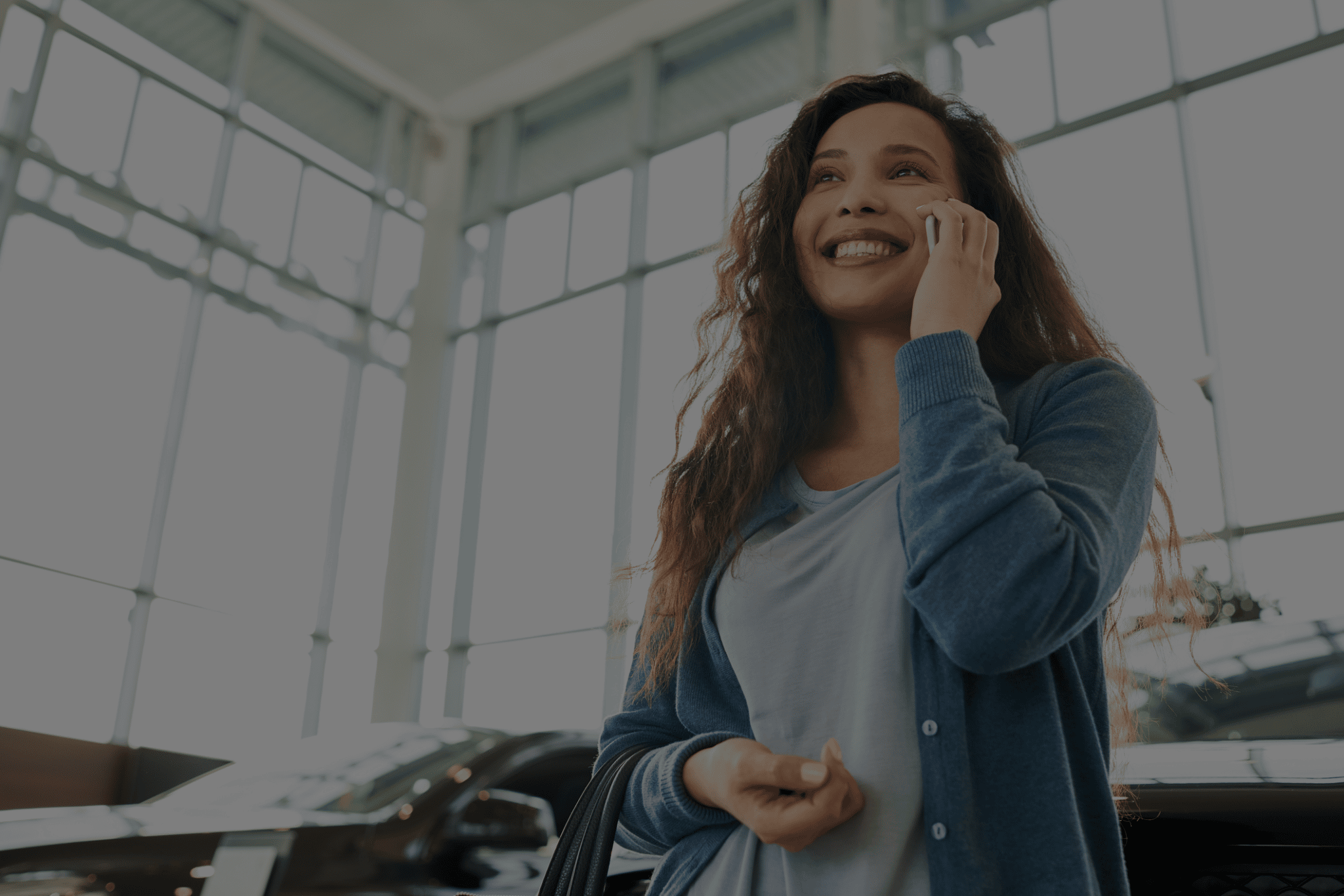 smiling woman calling to apply for lease buyout loan