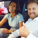 happy couple in new car